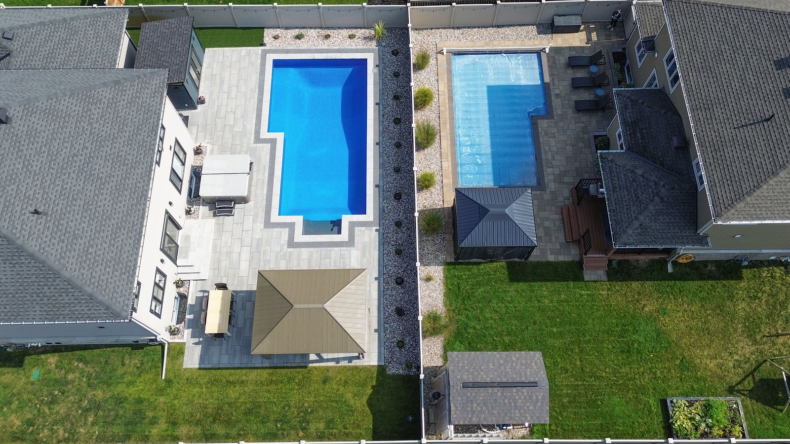 Overhead view of a linear pool with crisp geometry, surrounding hardscape, and adjacent pavilion and deck connections.